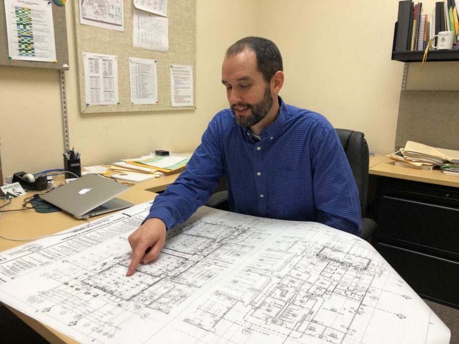Science Department Instructional Lead Erik Olah points to the location of four new classrooms. The latest floor plans show the expansion in the administration portion of the building. “Potentially we are going to expand [the teachers’] area of the building and add more teachers’ desks,” Olah said. 