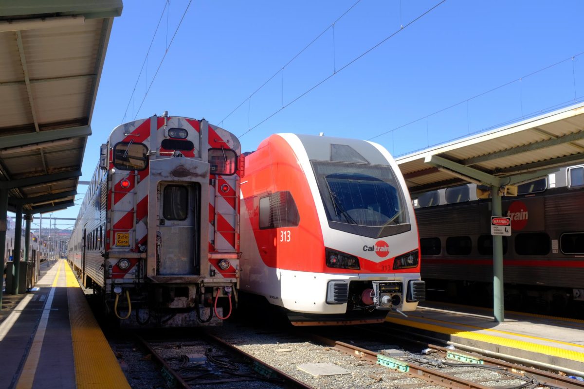 An electric Caltrain parks next to a diesel train at the San Francisco Caltrain station