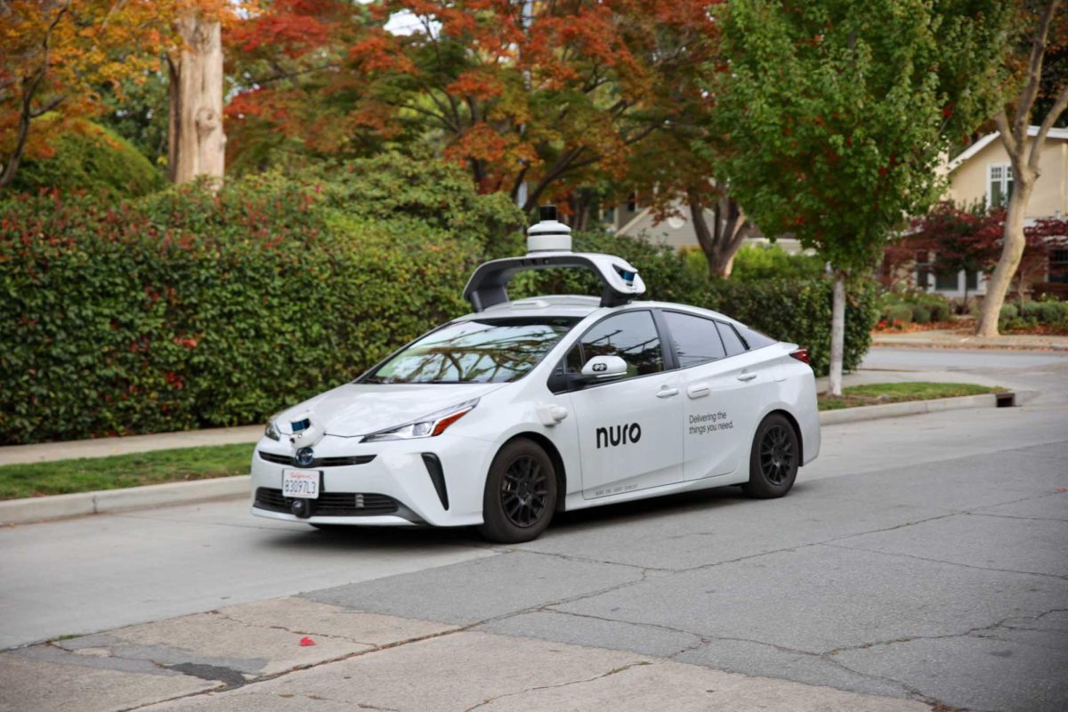A Nuro self-driving test vehicle travels through a Palo Alto neighborhood on Nov. 11, 2024. The autonomous car is part of the company’s efforts to develop delivery robots that can navigate public streets without a human driver.